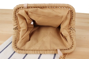 Interior view of paper rope woven bag showing the lining pocket and golden chain strap