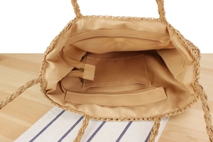 Internal view of khaki woven bag showing zipper pocket, smooth lining and spacious interior