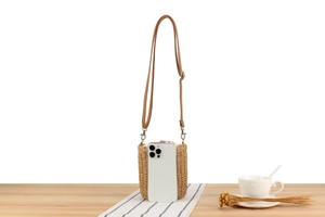 Mini straw bucket bag with wooden beads showing size comparison next to a phone