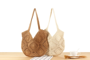 Detailed macro view of brown and cream knit tote bags with diamond hollow pattern