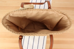 Top view of woven tote bag with spacious interior and brown leather handles