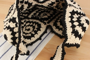 Detailed macro view of the crochet hand-woven tote bag with black and white swirl patterns