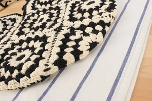 Detailed close-up of handmade crochet bag with black and white geometric diamond pattern
