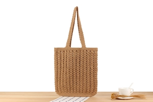 Detail of hollow crochet texture on brown cotton rope tote bag with bohemian pattern