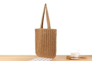 Detail of hand-crocheted hollow wave pattern on the brown cotton rope tote bag