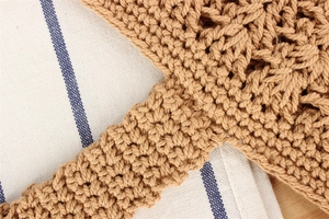 Close-up of khaki crochet cotton rope bag showing detailed hollow weave and texture