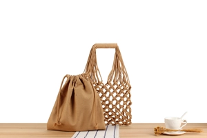 Detail of handmade woven hollow tote bag with a canvas drawstring inner pouch set
