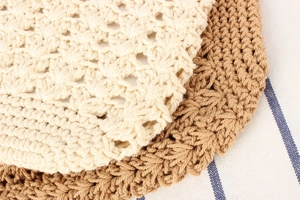 Close-up of handmade hollow crochet cotton weave in beige and light brown tones