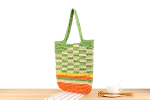 Macro shot of colorful paper rope woven tote bag showcasing detailed texture and stripes