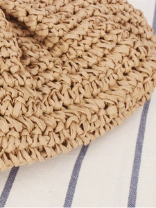 Close-up of a woven paper rope straw bag with intricate handmade textured patterns