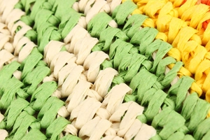 Macro view of color-block woven texture and twill weave pattern on the paper straw bag