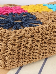 Handmade straw woven bag with colorful 3D crochet flowers for summer beach vacations