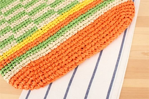 Detailed view of color block paper rope weaving with green, white, yellow, and orange texture