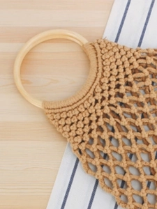 Handmade woven mesh tote bag with round wooden handles for beach and summer travel