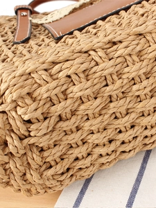 Fashionable woven straw shoulder bag with leather handles for summer beach vacations