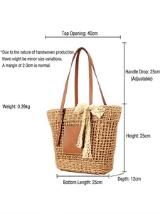 Handmade straw woven tote bag with brown leather pocket and lace bow on white background