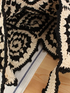 Handmade crochet shoulder bag with black and white swirl pattern in a vintage style