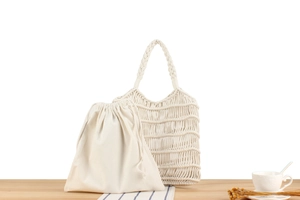 Detail of white macrame hand-woven cotton bag with inner canvas drawstring pouch
