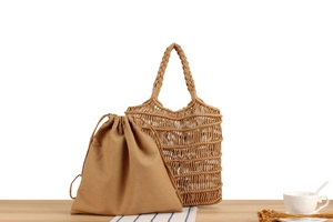 Detail of handmade woven mesh shoulder bag with a removable canvas drawstring pouch
