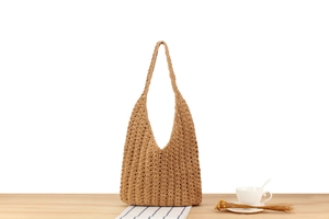 Detail of hand-woven cotton rope shoulder bag with hobo style and openwork crochet pattern