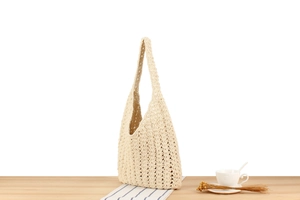 Detailed close-up of handmade cream cotton crochet tote bag with intricate floral knit texture