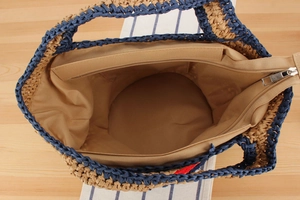 Top view of woven tote bag showing internal zipper pocket and khaki fabric lining details