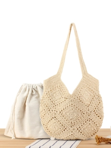 Beige crochet knit tote bag with floral cutouts and white drawstring inner pouch