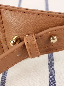 Brown lychee grain leather bag with gold rivets and detailed white stitching
