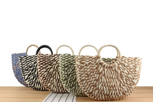 Detail of multi-color semi-circle woven paper straw tote bags with reinforced handles