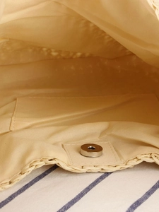 Handwoven paper rope tote bag interior with beige fabric lining and magnetic closure