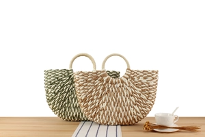 Detail of handmade two-tone woven paper rope bags with round handles for summer beach