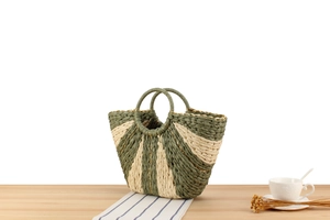 Detail of sage green and beige paper rope woven bag with stylish circular top handles