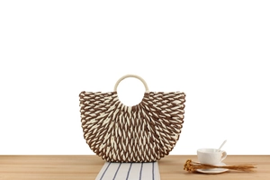 Detail of two-tone paper rope woven bag with elegant herringbone pattern and round handles