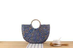 Detailed weave of a blue and natural bicolor semi-circle paper rope woven tote bag
