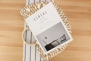Top view of handmade dual-tone paper rope woven bag with round handle on a table