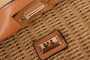 Macro shot of paper rope weaving texture and gold metal buckle hardware on bag