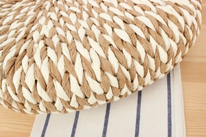 Macro view of bicolor woven paper straw material showing intricate handcrafted texture