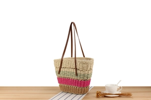 Detail of colorful paper rope woven shoulder bag with faux leather handles for summer beach