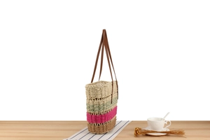 Detail of hollow woven paper rope tote bag with colorful stripes and faux leather handles