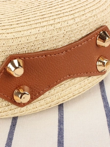 Artistic beige woven round crossbody bag with brown leather patch and gold studs detail