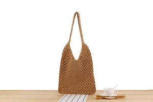 Détail du motif au crochet évidé sur un sac cabas bohème en coton tissé marron