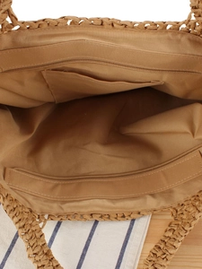 Sac fourre-tout en paille tissée main montrant la poche intérieure zippée et la doublure