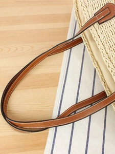 Large colorful paper rope woven shoulder bag with brown leather straps for beach holidays