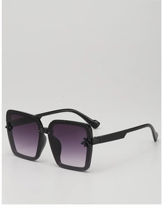 Detail of square children's sunglasses with purple gradient lenses and bee decoration