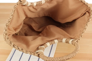 Top view of large woven straw tote bag showing spacious interior and handles