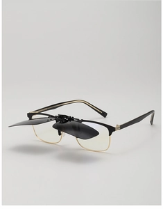 Detail view of flip-up polarized sunglasses clip attached to a black and gold frame