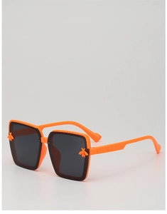 Detailed view of orange square sunglasses with gold bee accent and textured temples