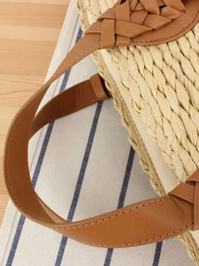Handwoven straw tote bag with brown leather handles for casual summer beach vacations