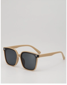 Detail view of retro large frame kids sunglasses in matte beige with dark black lenses