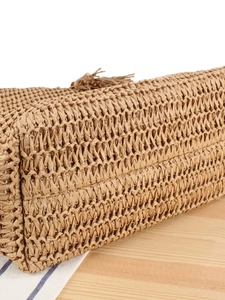 Large straw tote bag with woven texture and tassel detail for summer beach vacation